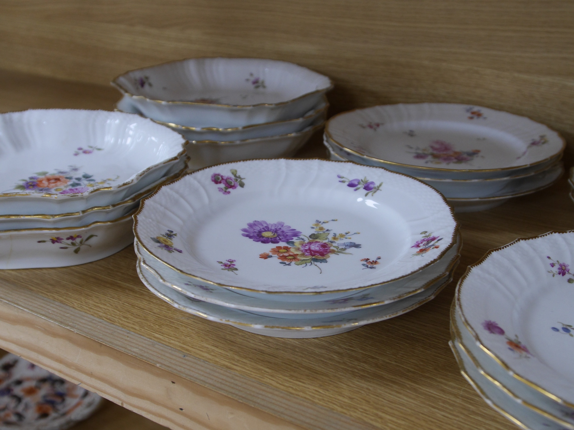 A 19th century Copenhagen floral and gilt decorated part dessert service, dishes 23cm wide. Condition - gilt edging worn